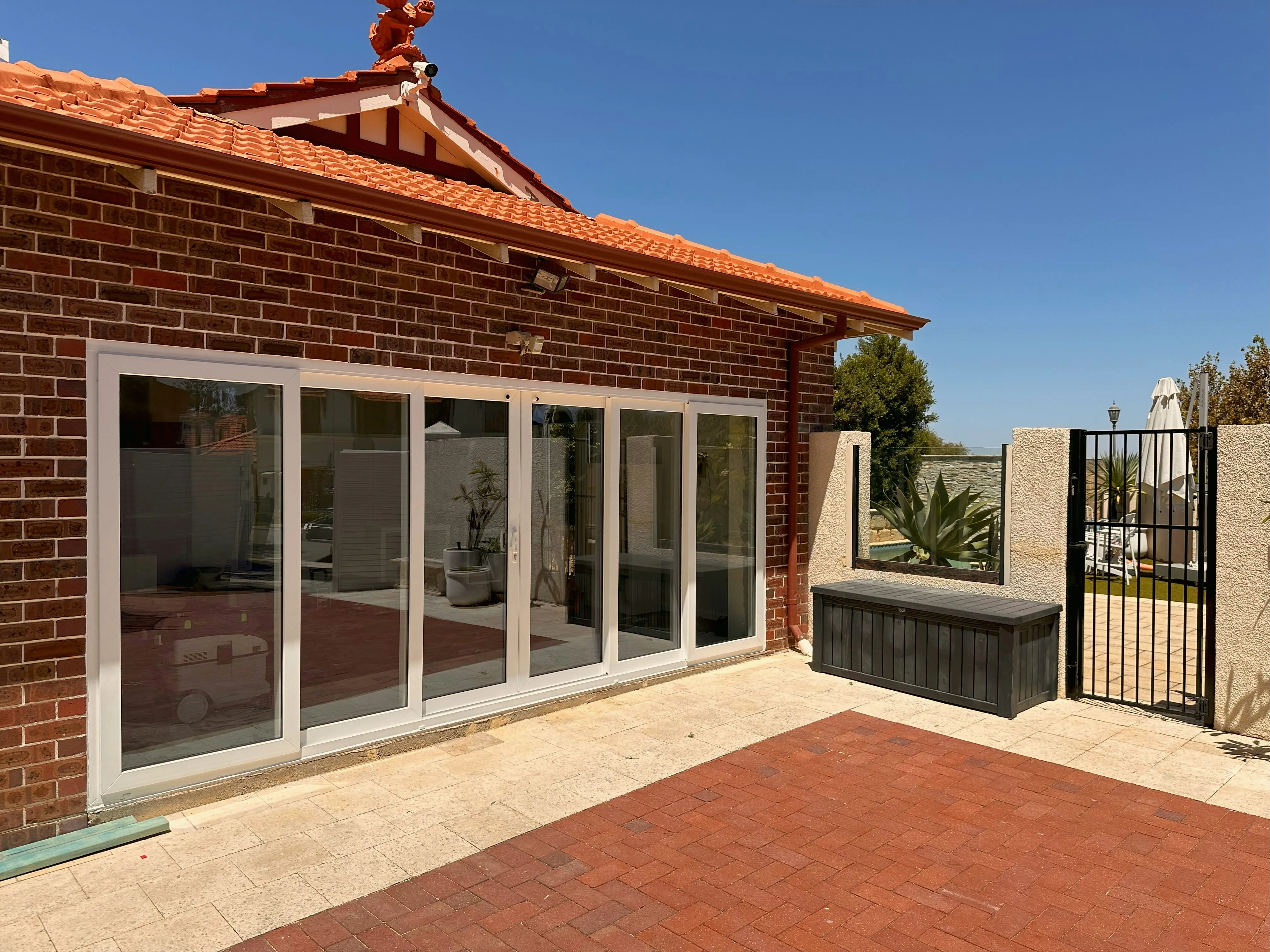 White sliding-door suite on heritage brick home
