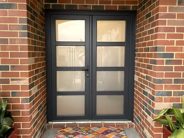 Anthracite French door pair with glazed panels on red brick