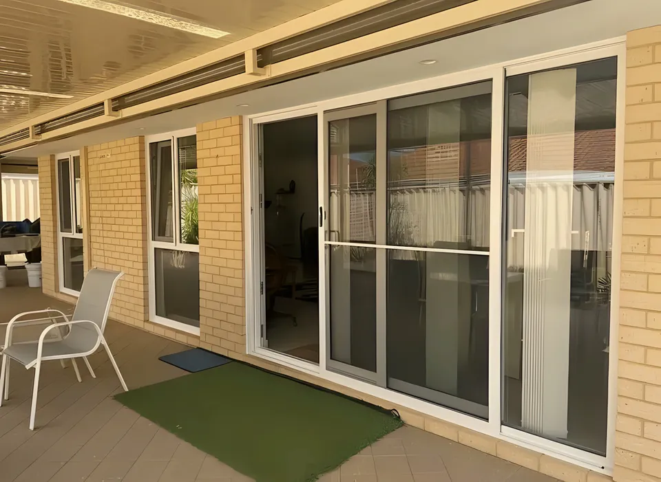 White sliding doors opening onto covered alfresco area