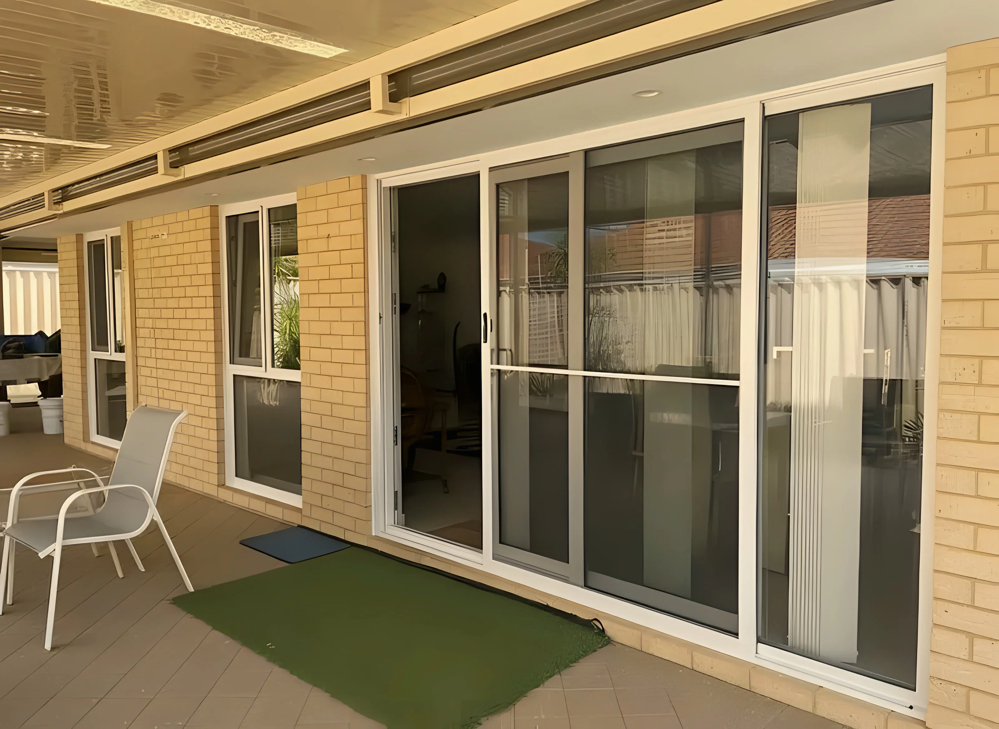 White sliding doors opening onto covered alfresco area