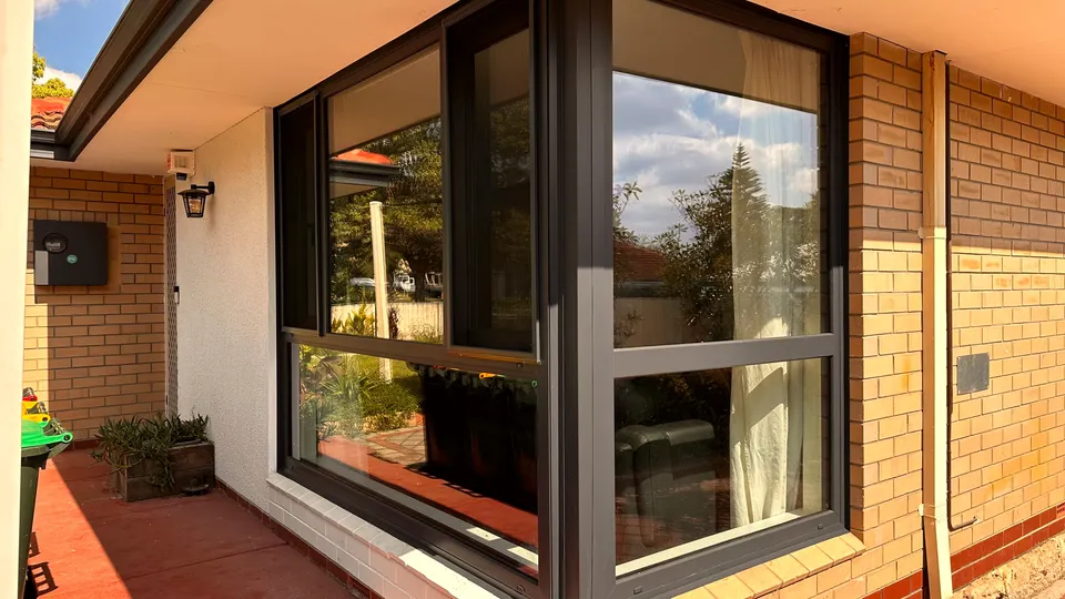 Anthracite-framed window retrofitted into an existing brick 1970s-era Perth home