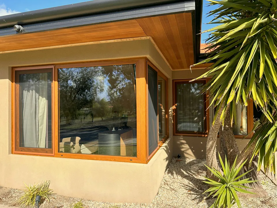 Wide view of golden-oak corner window installation