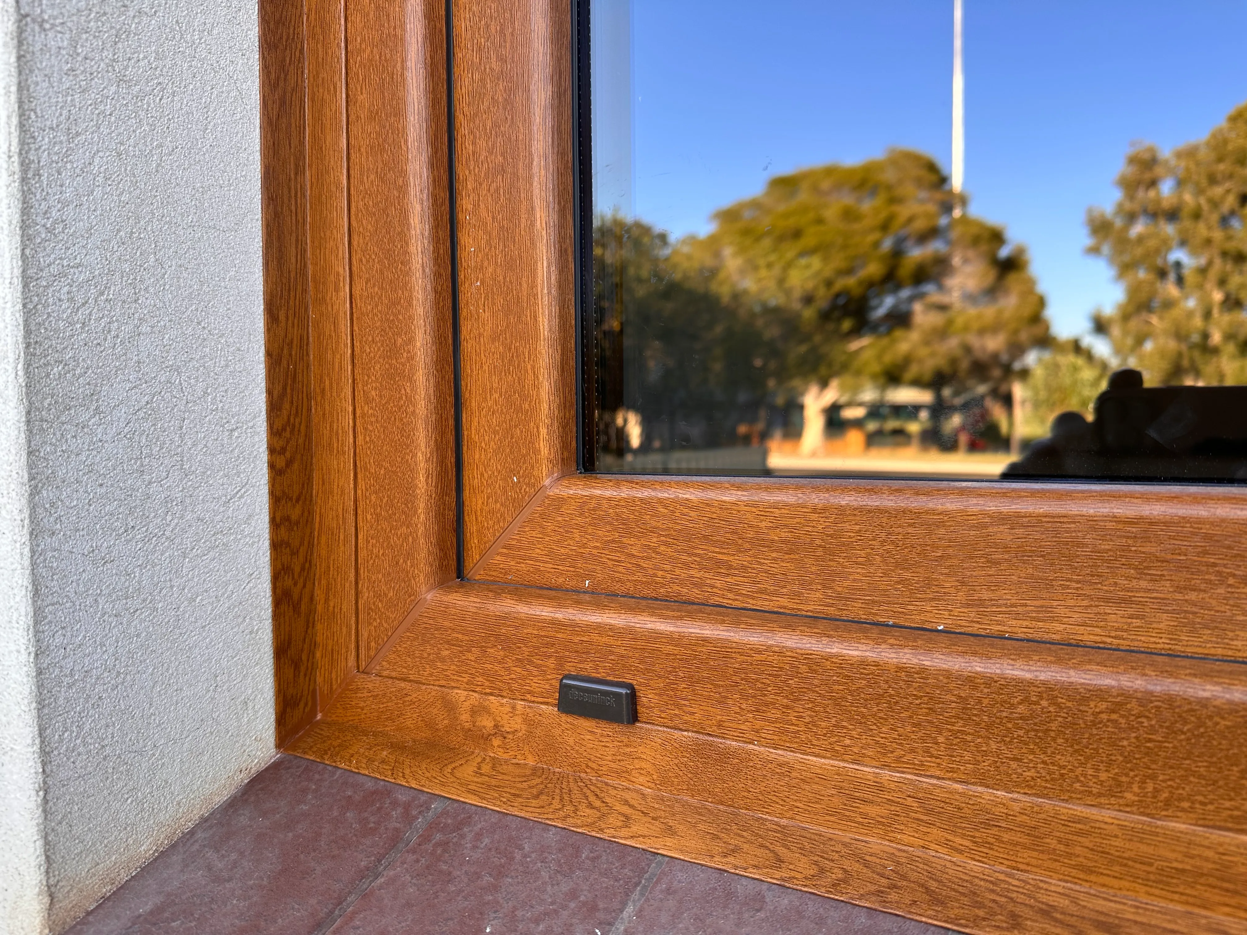 Close-up of woodgrain uPVC window frame finish