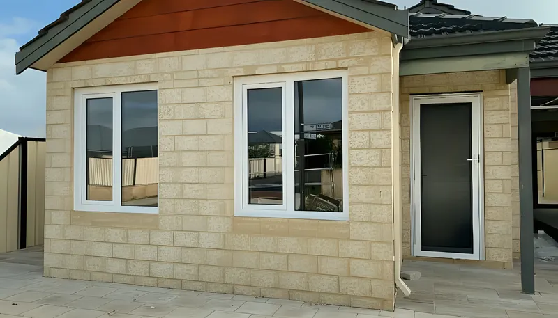White double-glazed windows on limestone-block new build