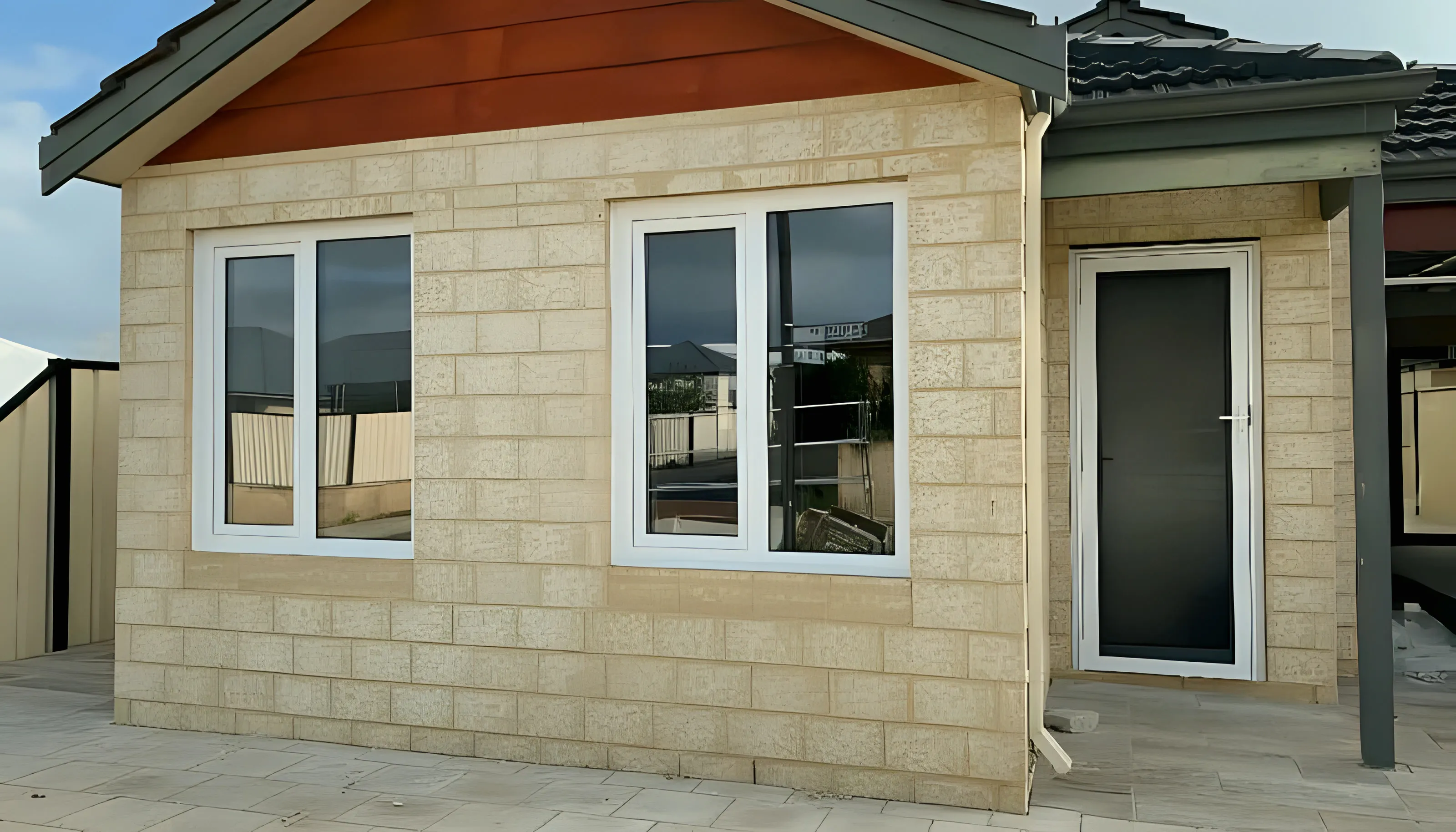 White double-glazed windows on limestone-block new build