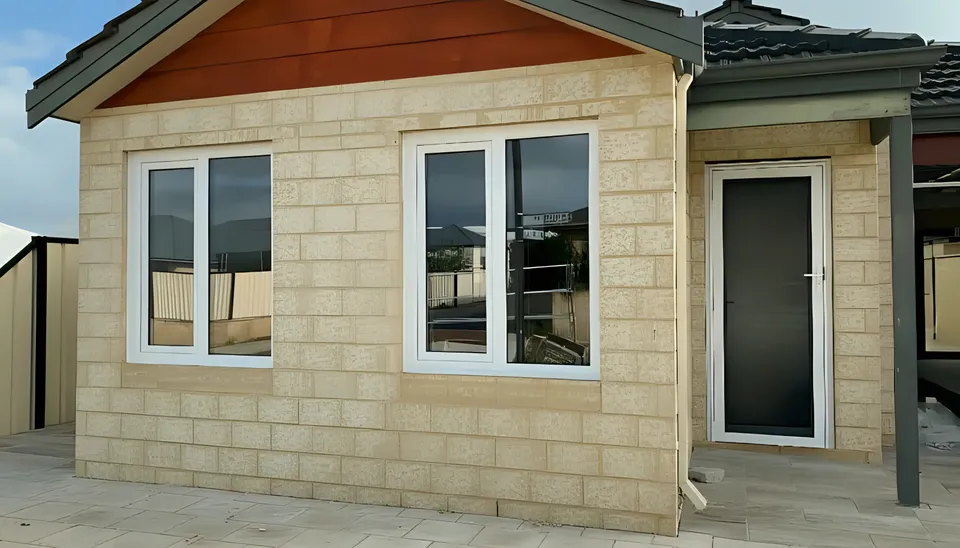 White double-glazed windows on limestone-block new build