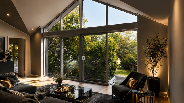 Contemporary dark-framed balcony doors in a warm luxury living room